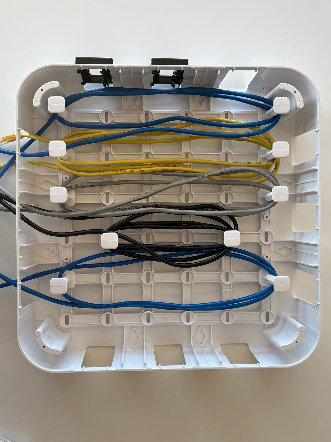 Wire Wonder cable management box showing 5 cables routed with 10  adjustable pegs