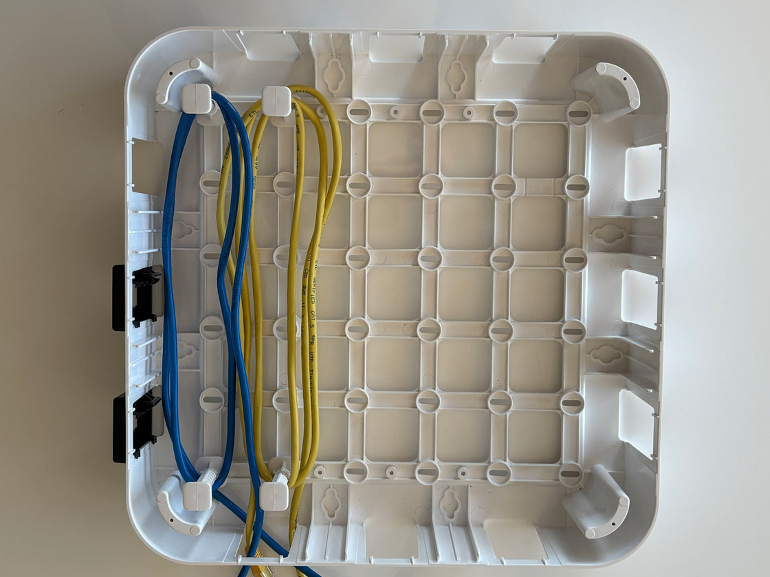 Wire Wonder cable management box, 2 cables routed with 4 pegs