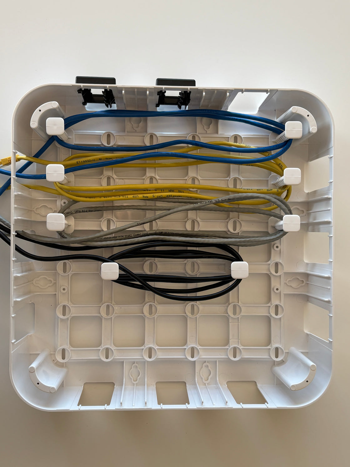 Wire Wonder cable management box, 4 cables routed around 8 adjustable pegs